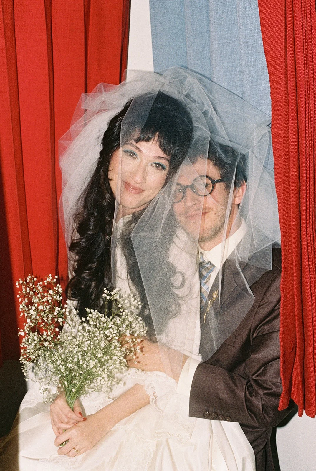Bride and groom posing in the vintage photobooth at Sure Thing Chapel.
