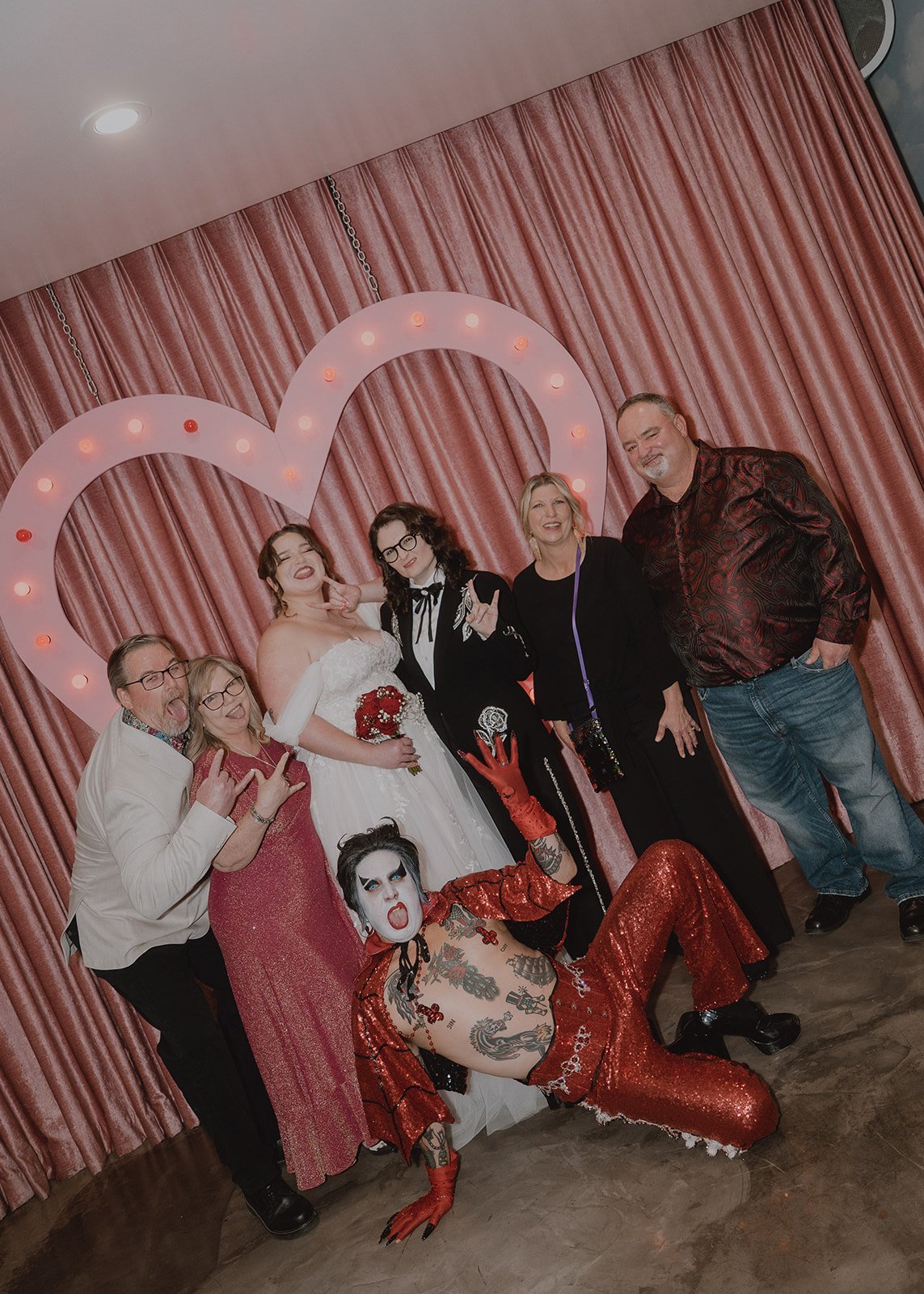 Couple and their parents posing with Hellvis after their Sure Thing Chapel wedding ceremony.
