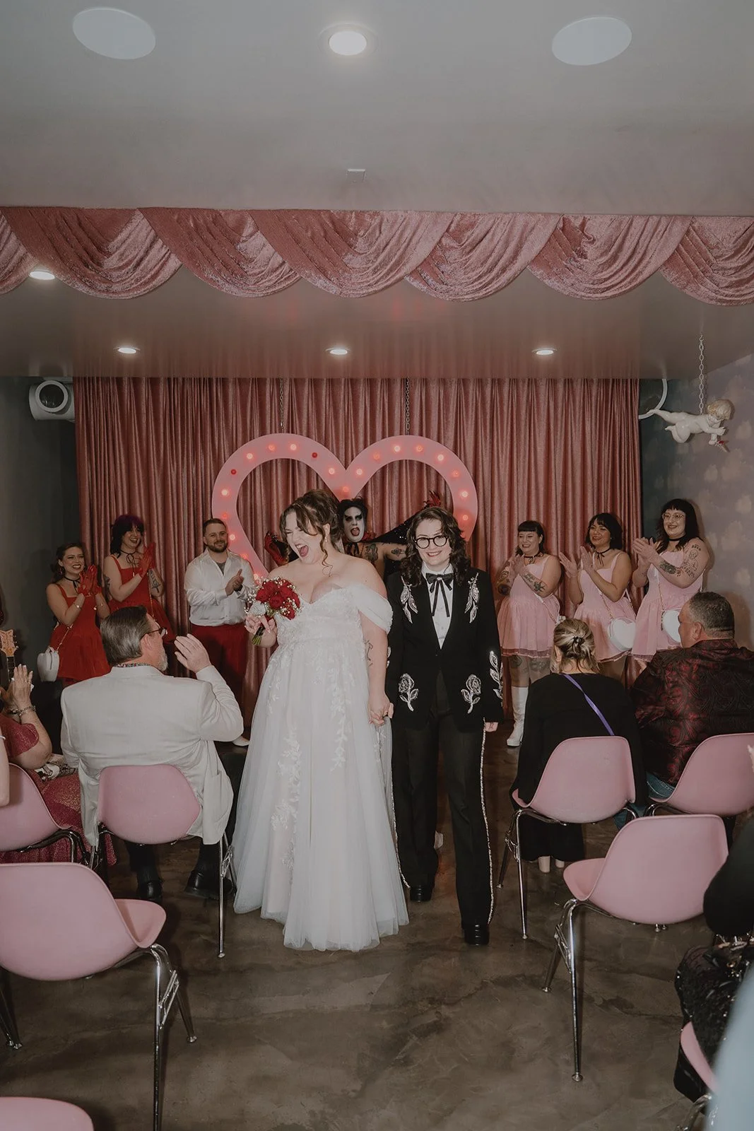 Couple walking together during their Hellvis wedding ceremony at Sure Thing Chapel.