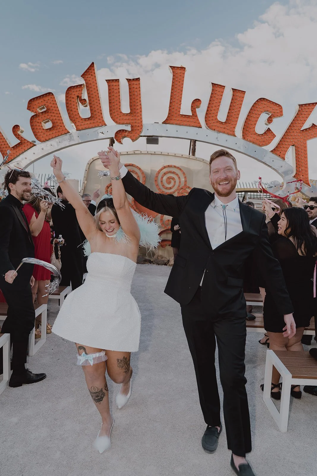 Bride and groom walking back down the aisle as husband and wife after their Neon Museum wedding ceremony in Las Vegas.