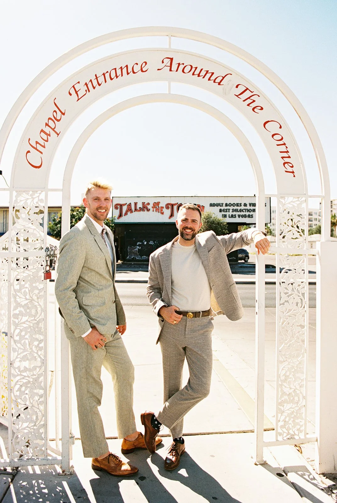 Couple smiling while posing for their Little White Chapel elopement in Las Vegas on 35mm film.
