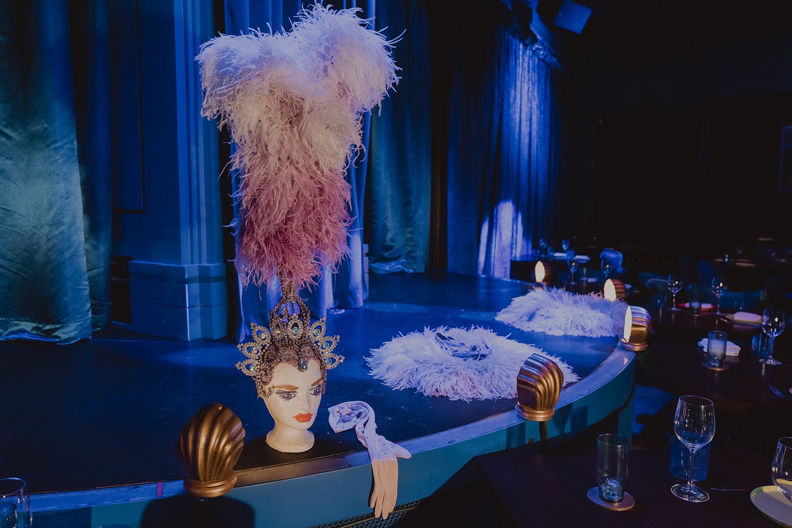 Showgirl headpiece displayed at the edge of a Las Vegas stage during the Showgirl Bootcamp Experience.
