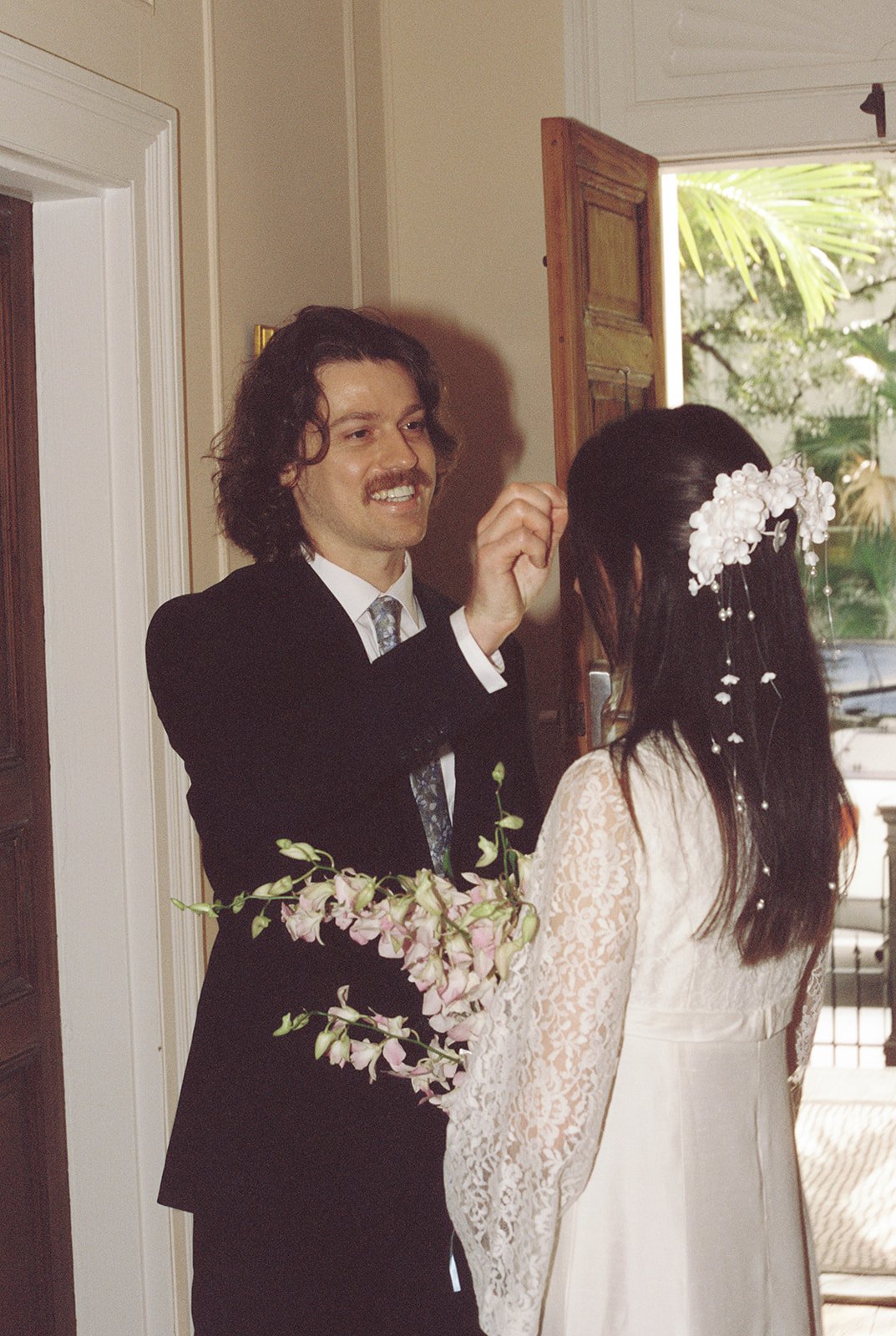 Groom admiring his bride to be captured on 35mm film inside of Old Town Manor of Key West Florida.