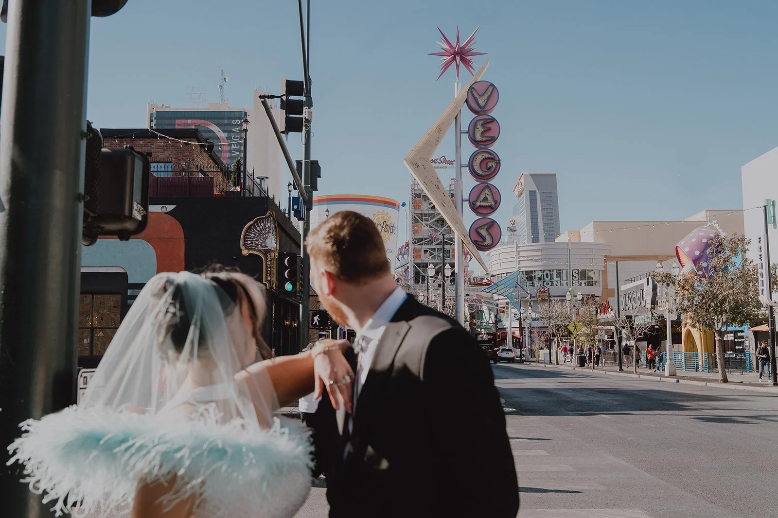 Bride and groom posing in downtown Las Vegas for their wedding photos,