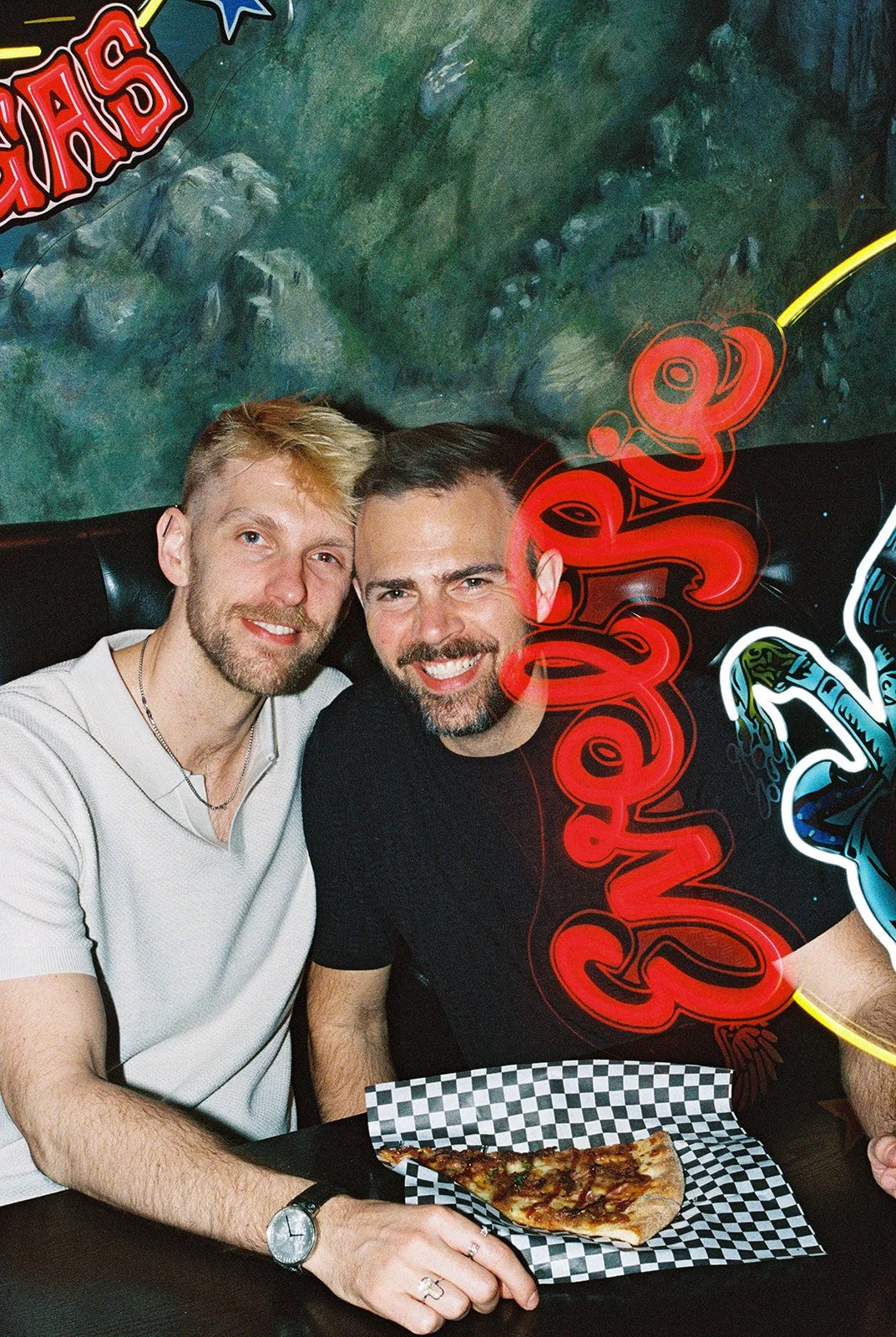 35mm film photo of a couple having pizza at Evel Pie in Las Vegas.