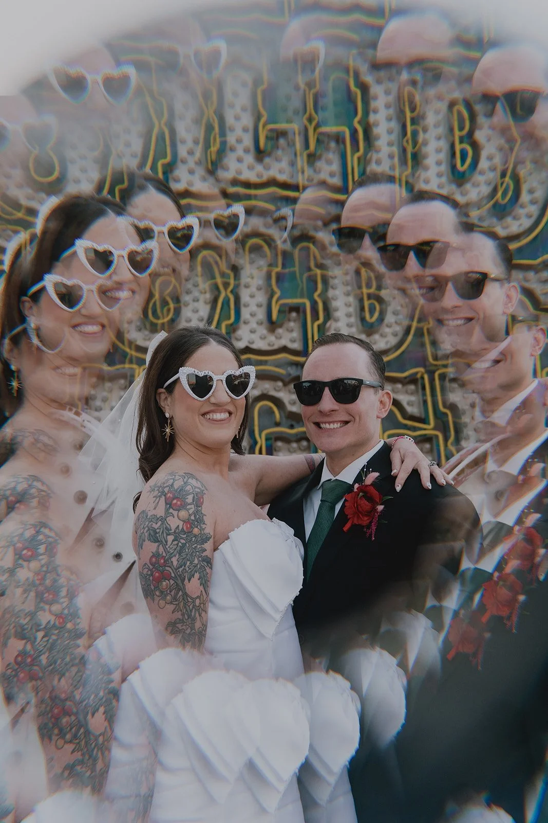 Creative double-exposure style portrait of the couple with neon signage layered behind them at the Neon Museum.