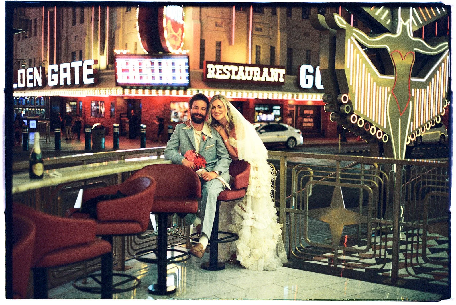 Bride and groom sitting at Carousel Bar in Las Vegas on 35mm film.