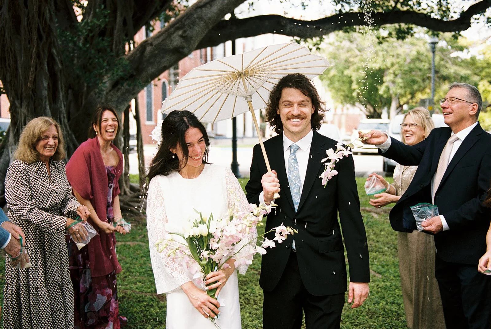 Bride and groom walking back down the aisle with a rice toss after their Key West Florida elopement.