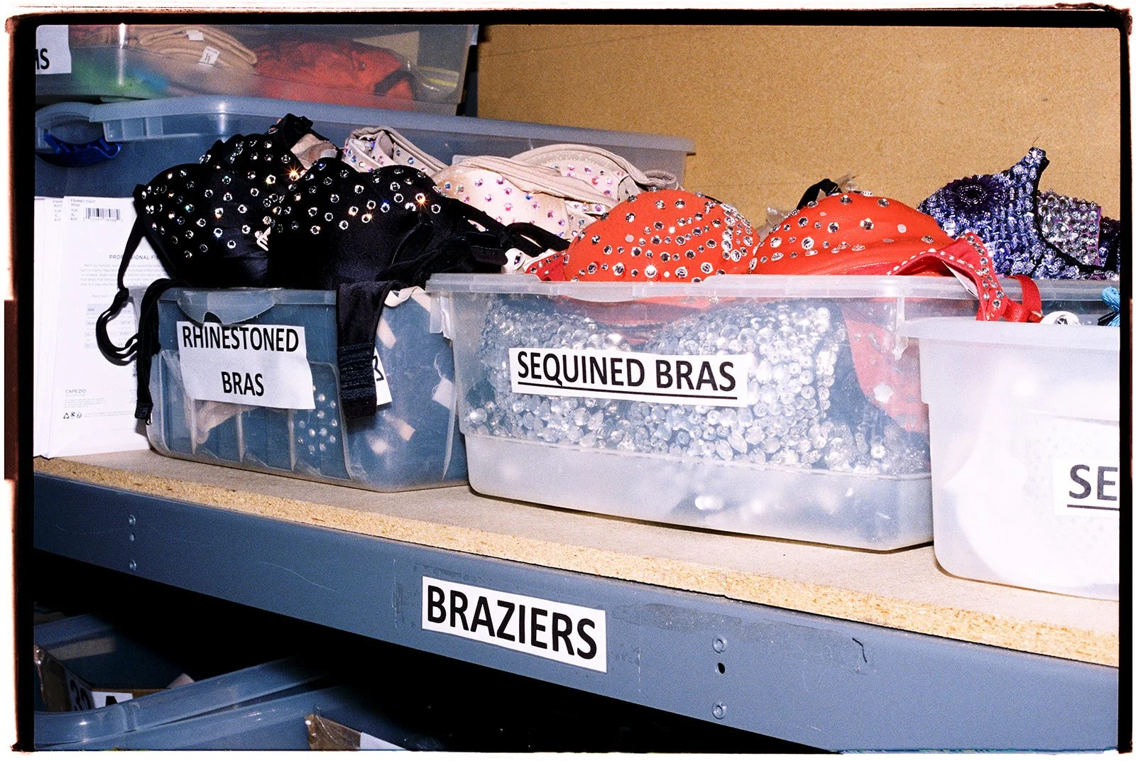 Shelves of rhinestoned and sequined showgirl bras used in Las Vegas productions, photographed during the Showgirl Bootcamp Experience.
