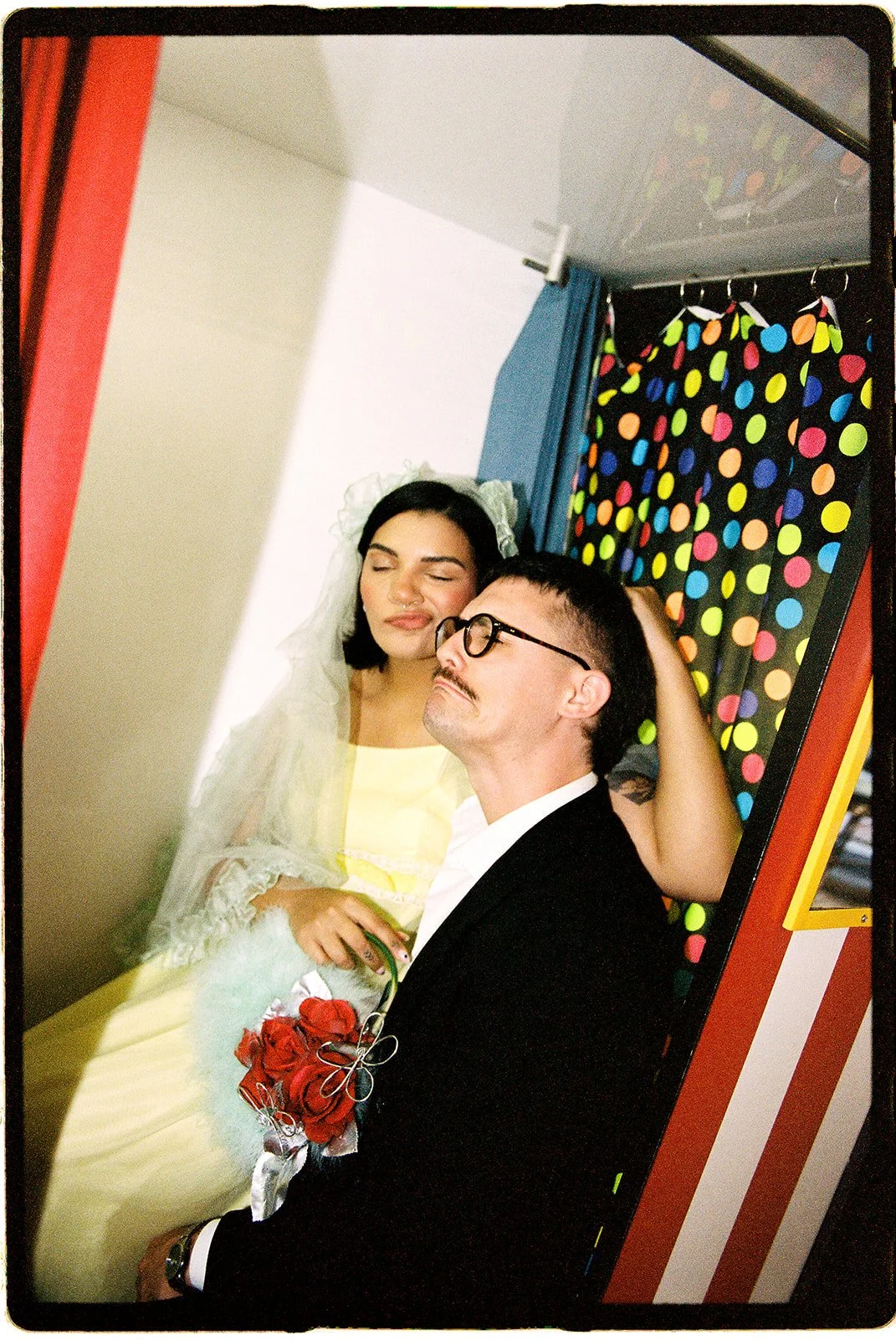Couple posing together inside a vintage photobooth at AUTOPHOTO near Sure Thing NYC, photographed on 35mm film.