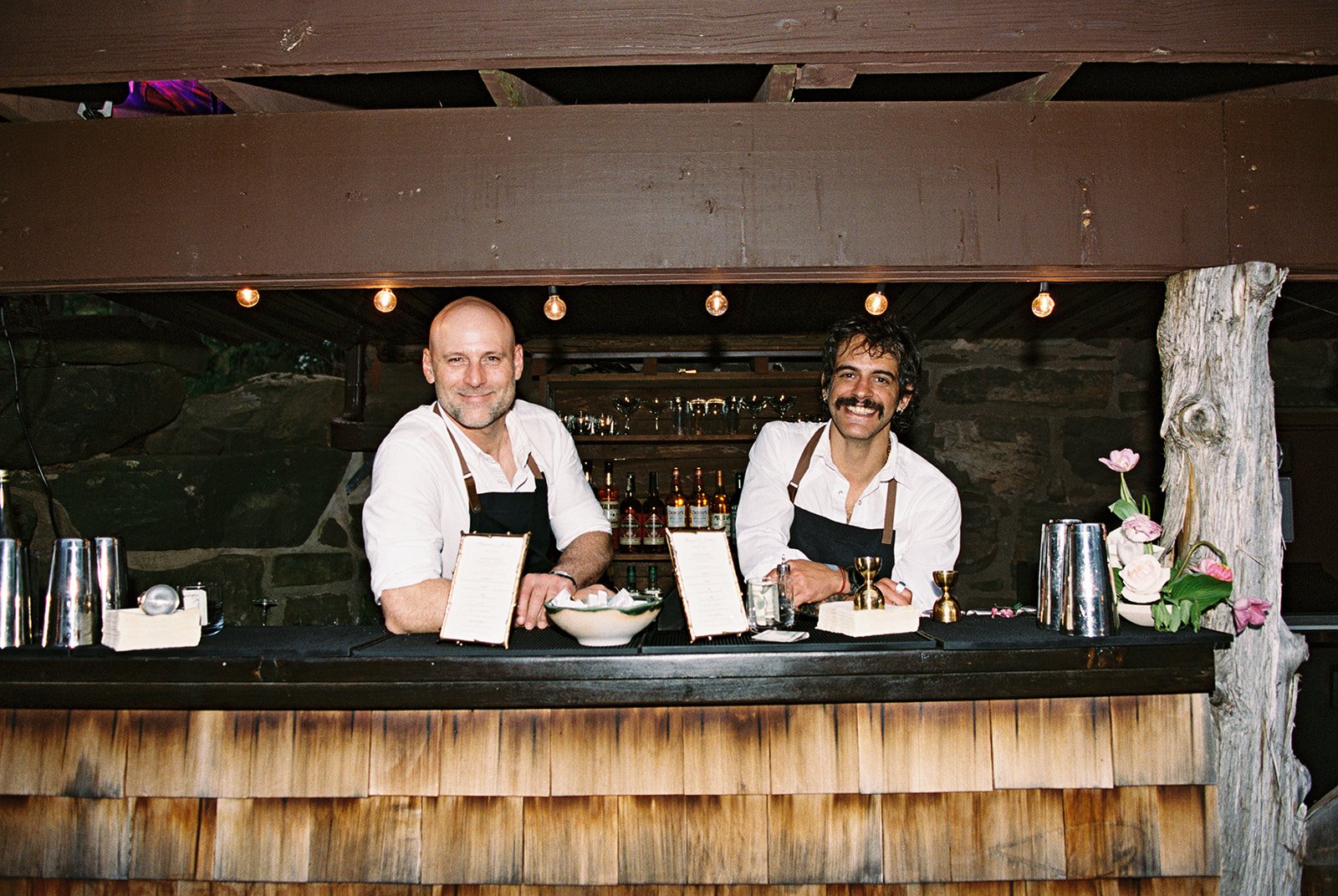 Bartenders posing for a photo during cocktail hour.
