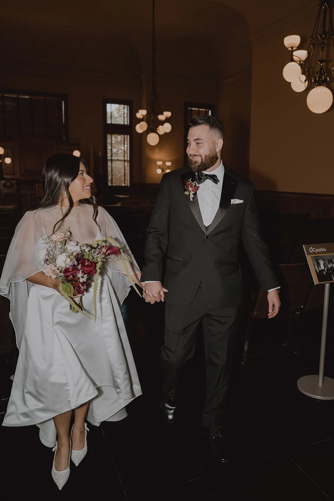 Couple walking back down the aisle after their Old Orange County Courthouse wedding.