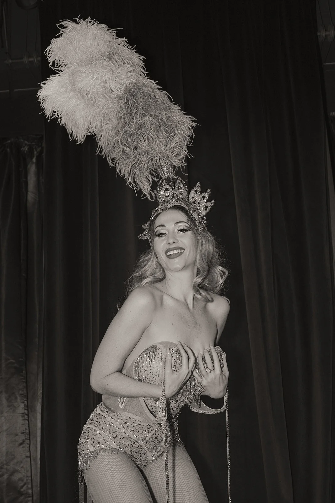 Portrait of Las Vegas showgirl Gypsy Wood wearing a feathered headpiece during the Showgirl Bootcamp Experience.