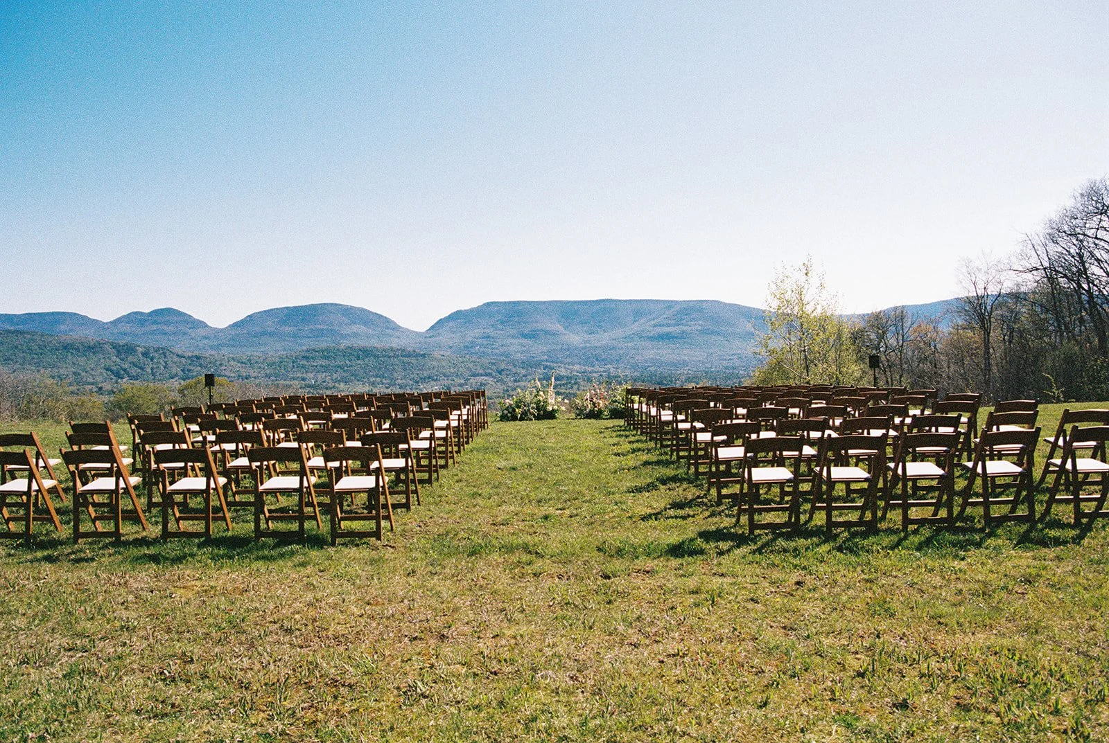 Outdoor hilltop wedding ceremony setup on film in the Northern Catskill Mountains.