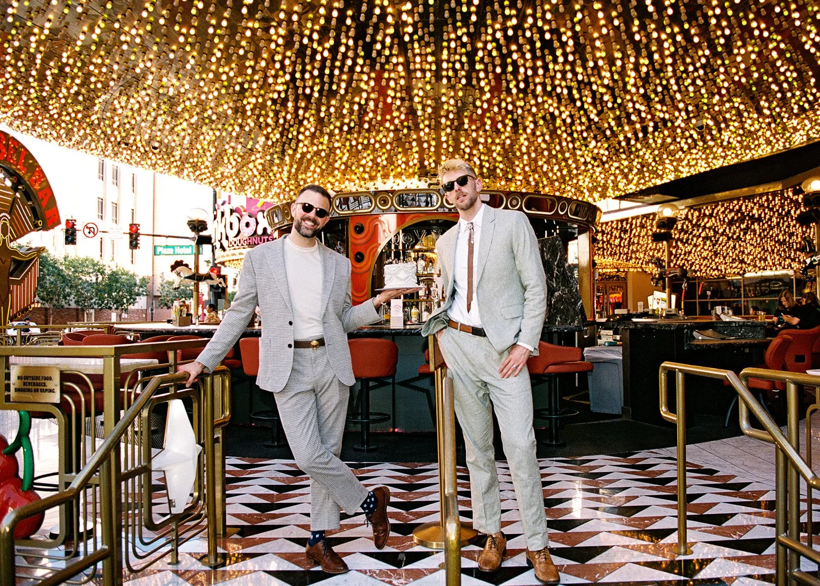 Couple posing with their cake at Carousel Bar on Fremont Street on 35mm film.