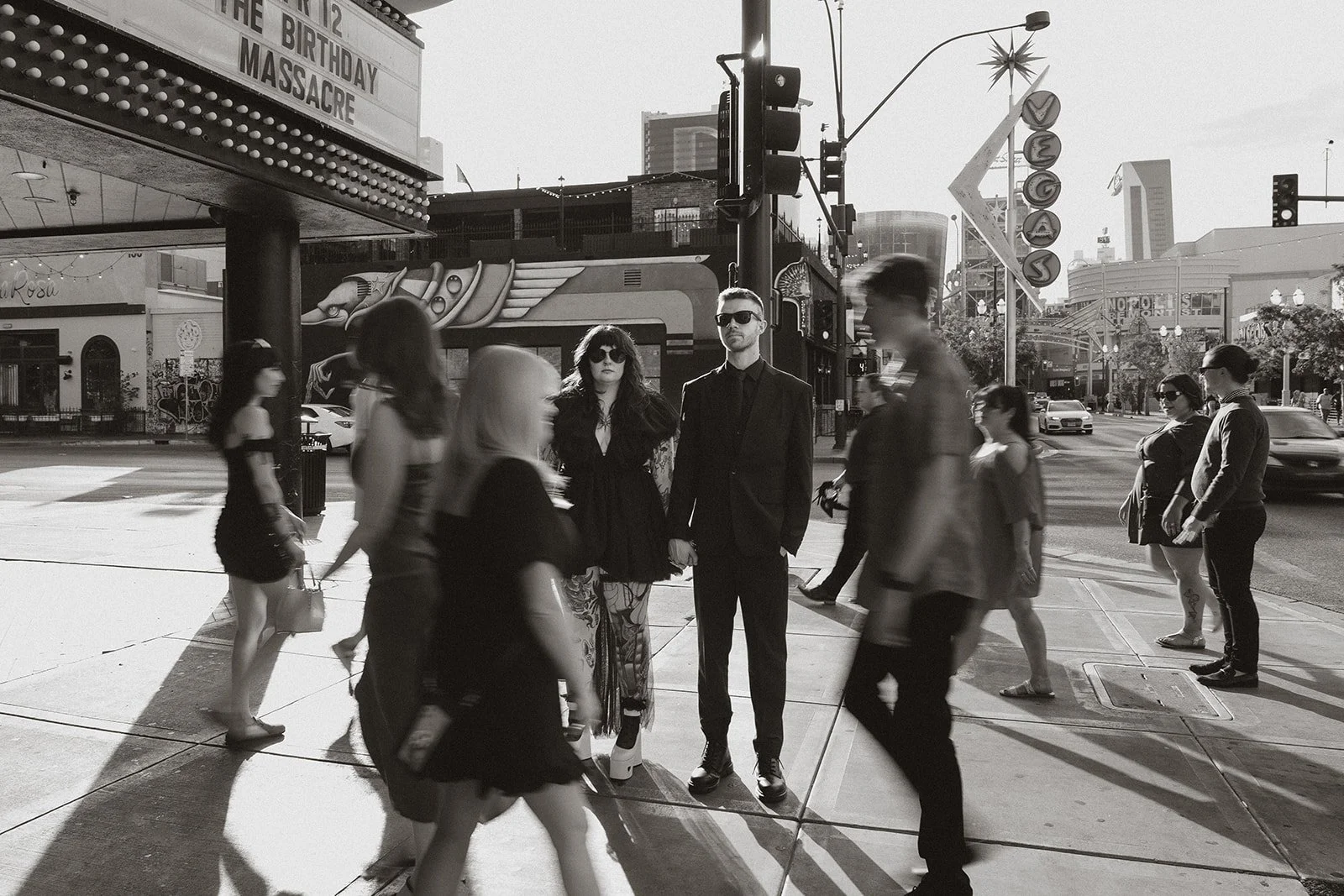 Black and white motion blur photo of a couple and their friends on Fremont Street.