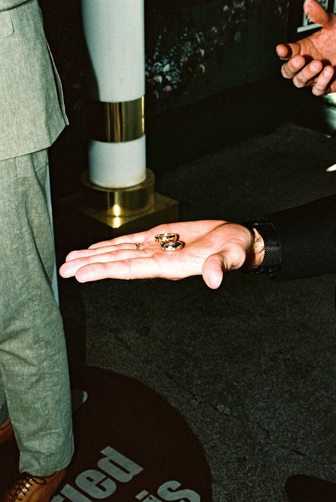 Officiant holding out the grooms rings during their ceremony.
