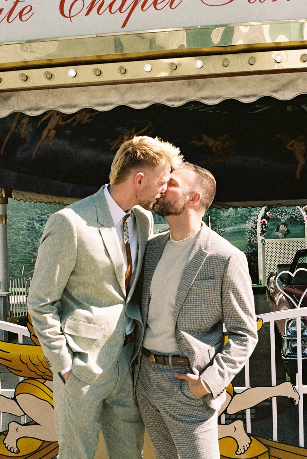 Couple kissing outside of Little White Wedding Chapel in Las Vegas.
