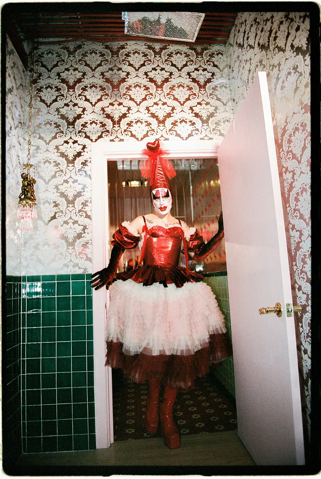 Tillie the Clown posing in the bathroom at Sure Thing NYC.