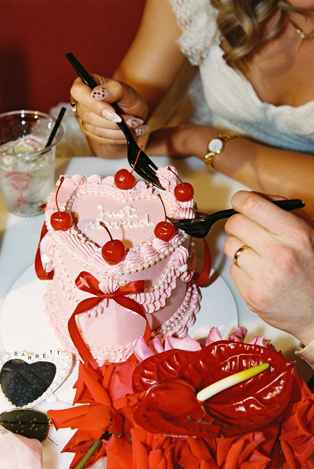 Close up shot of a bride and groom digging into their cake by Winston Marie Cakes.