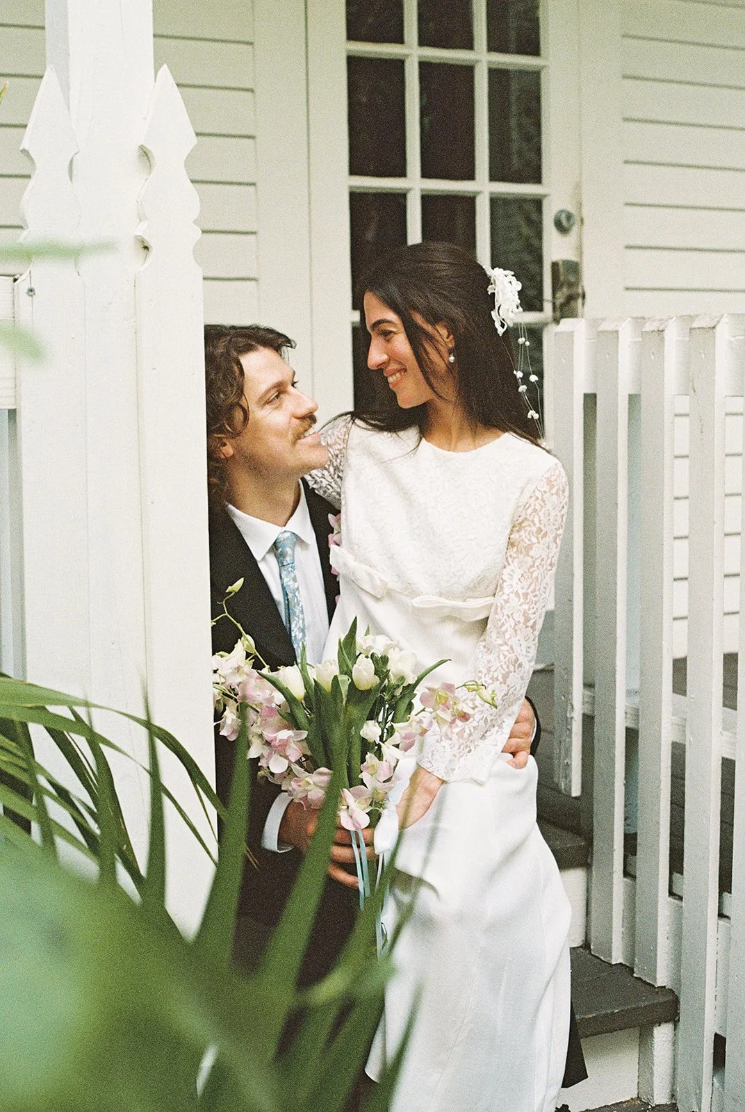 Bride and groom embracing on the front steps of Old Town Manor in Old Town Key West.