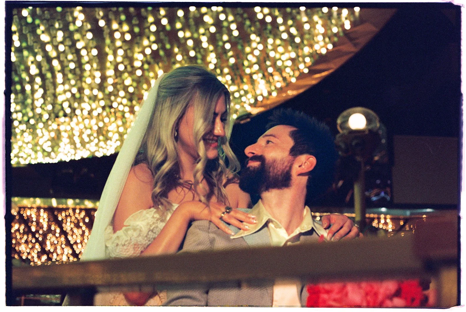 Bride and groom standing together during their Las Vegas elopement photos at Carousel Bar on 35mm film.