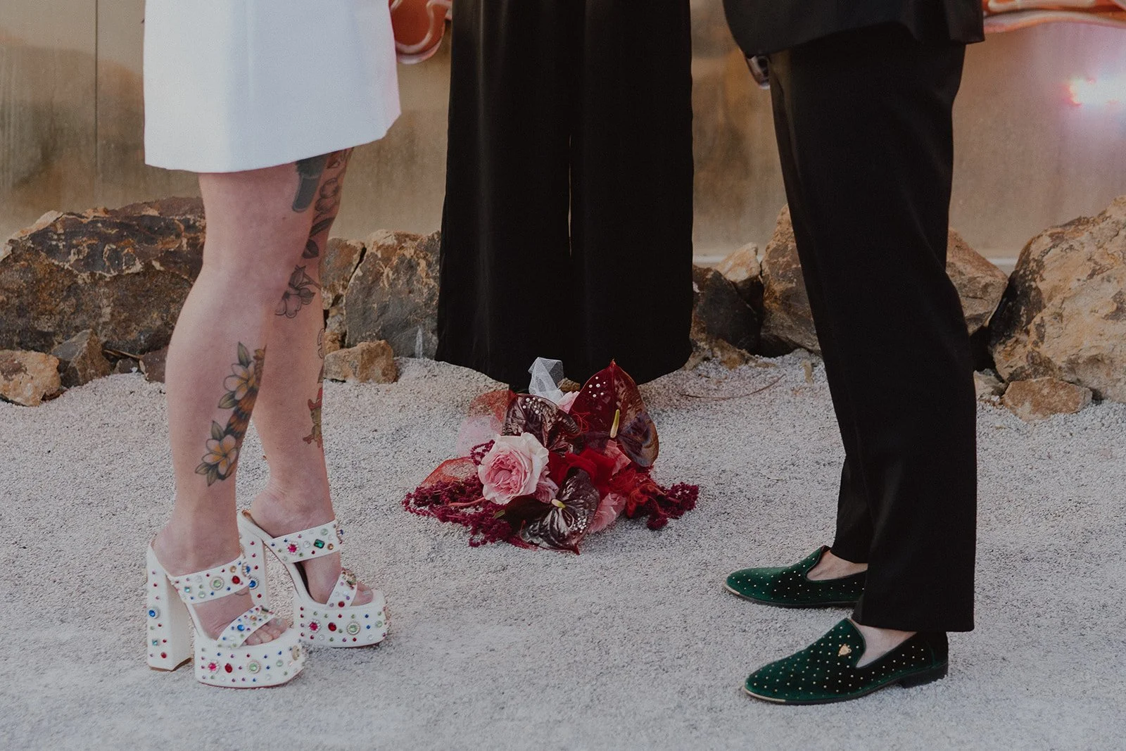 Detail shot of the bride’s jeweled platform heels and groom’s green loafers during their Neon Museum Las Vegas wedding.