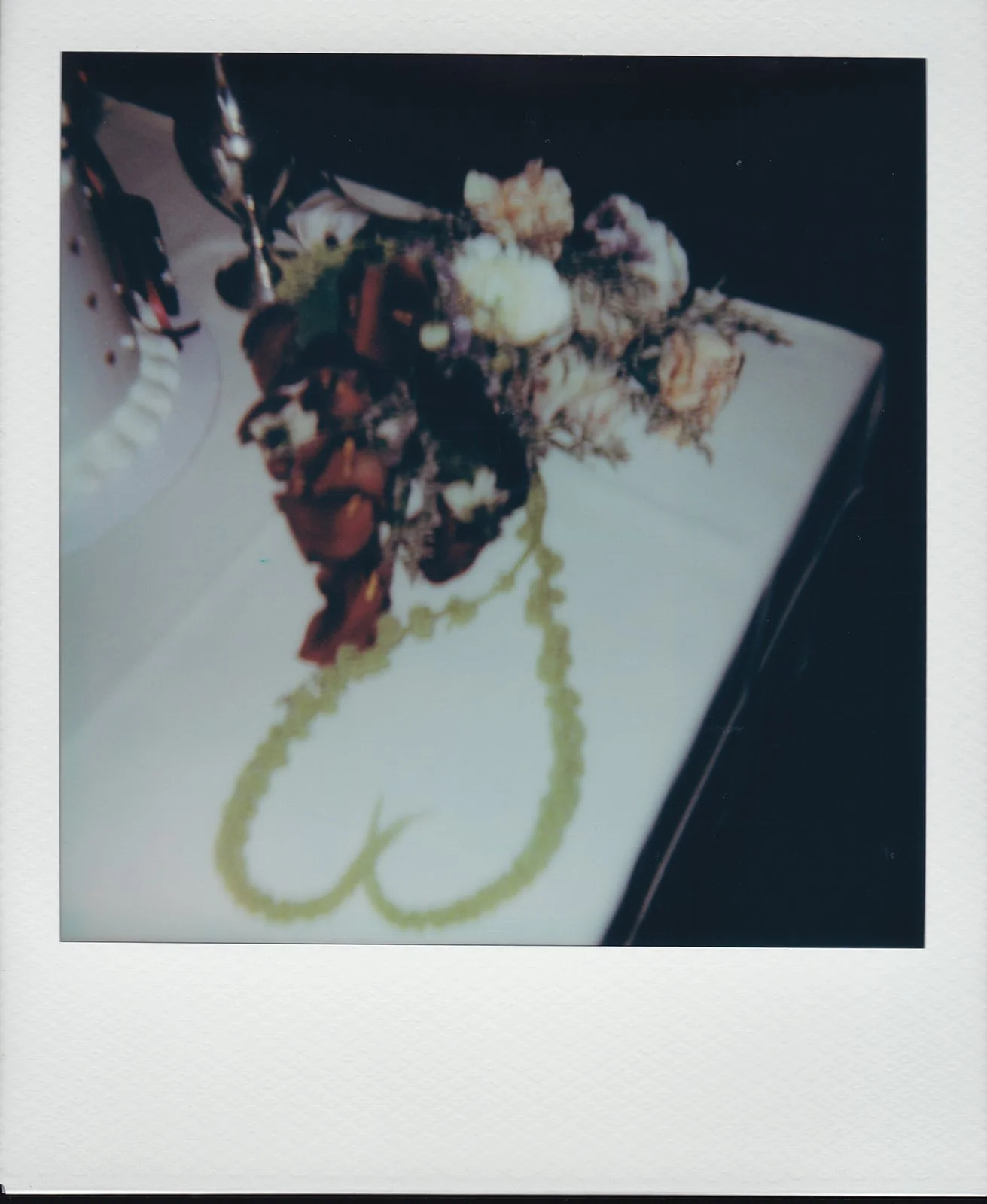 Micro wedding brunch detail shot of florals next to a cake.