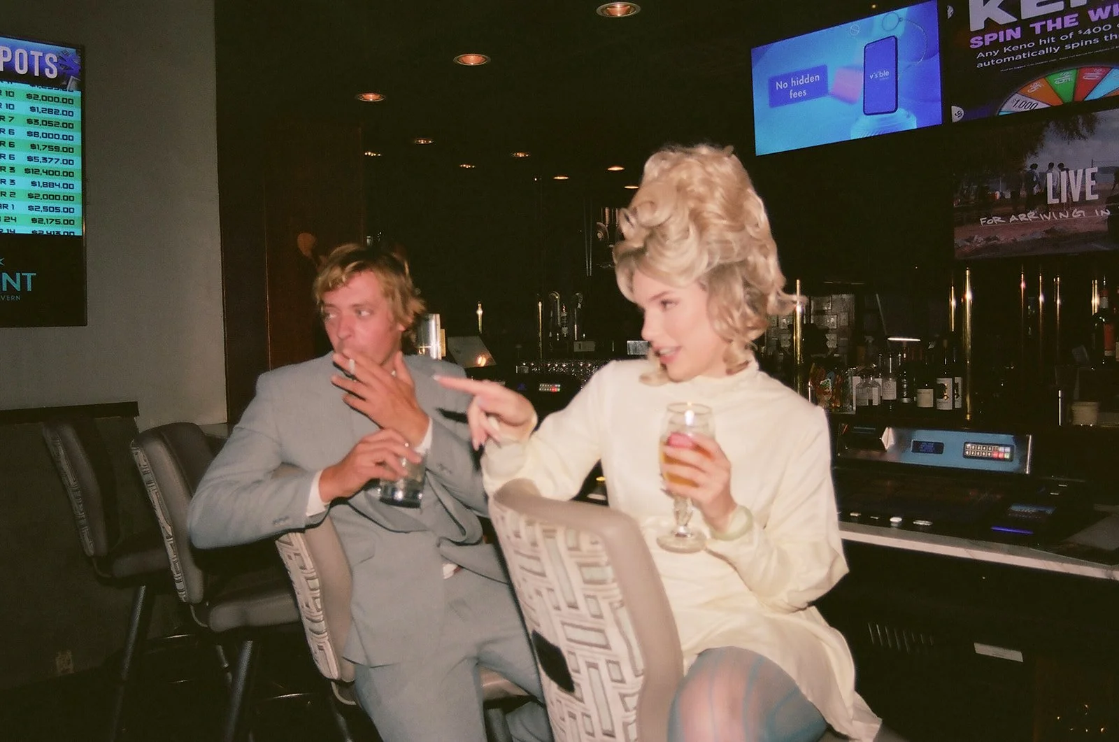 Couple having drinks inside The Mint Tavern for their vintage Vegas wedding photos.