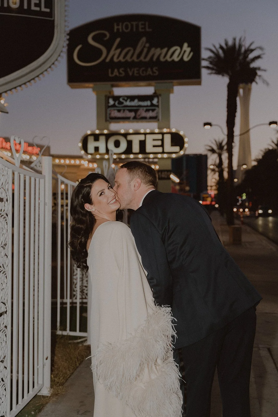 Groom kissing the bride outside of Hotel Shalimar in Las Vegas.