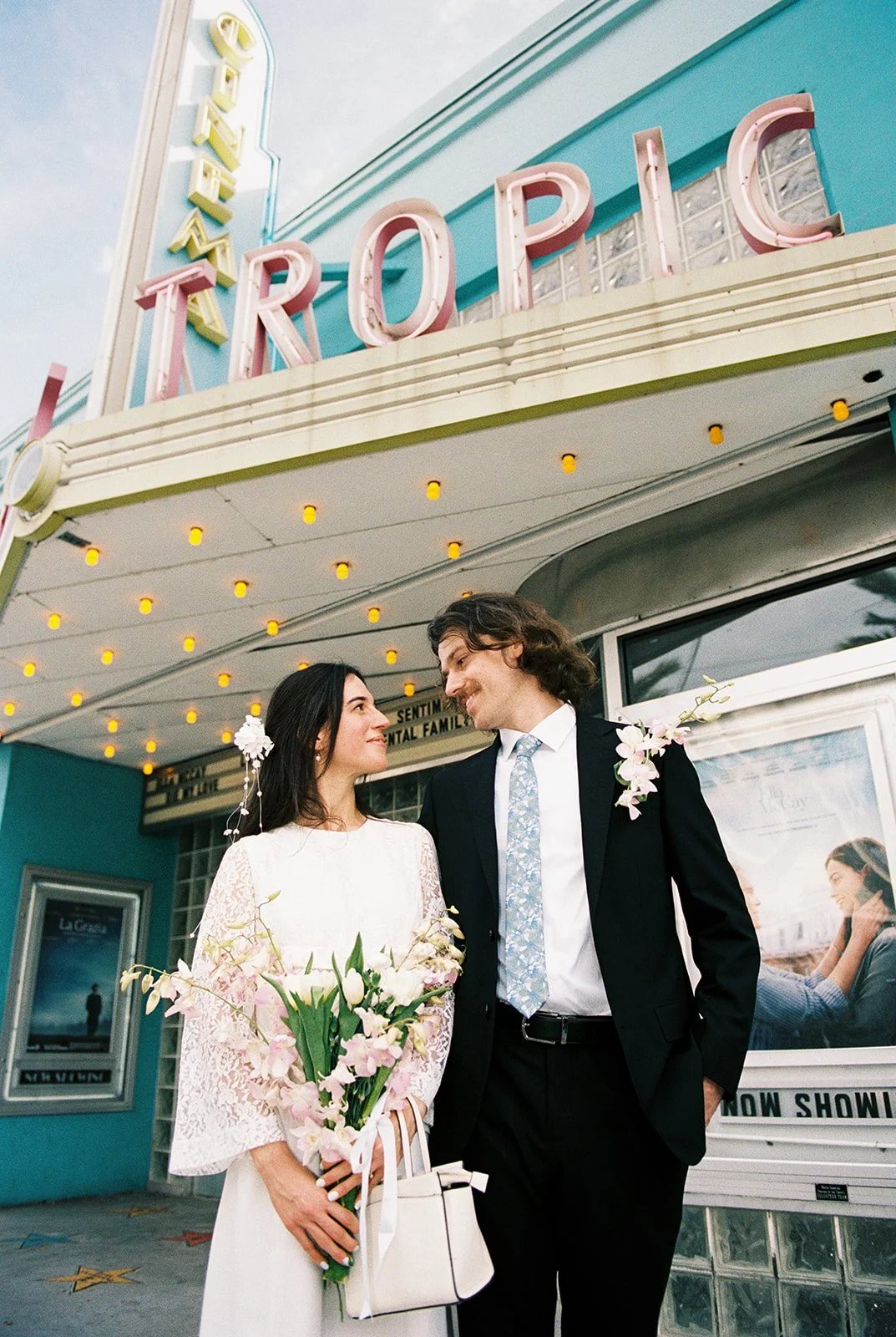 Couple posing in front of Tropic Cinema on 35mm film.