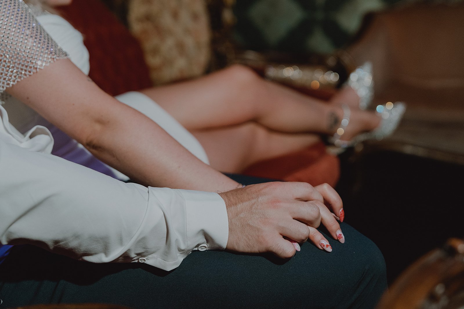Close up of a bride and groom seated together on a velvet couch during their Velveteen Rabbit micro wedding reception.