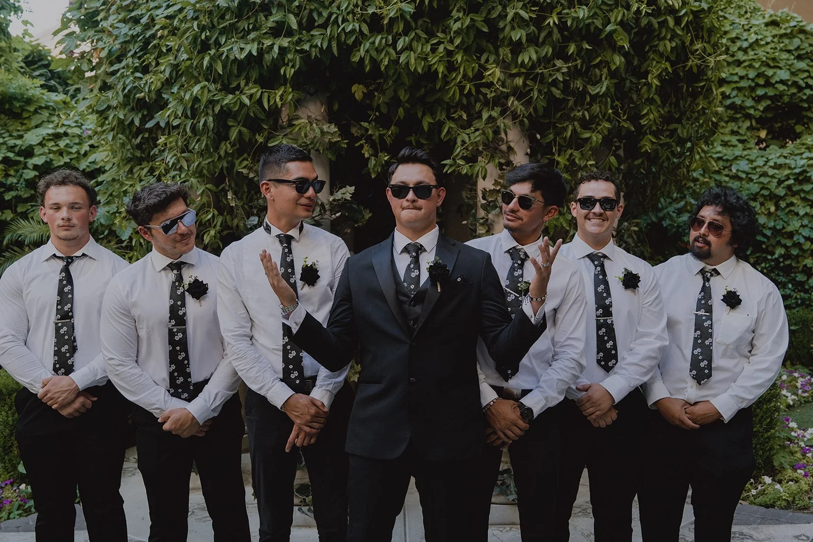 Groom laughing with his groomsmen during wedding party portraits at the Venus Garden at Caesars Palace.