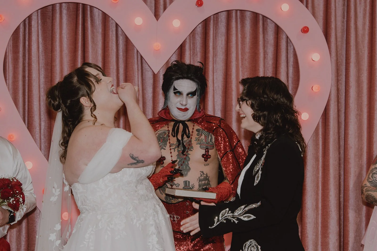 Couple laughing during their Sure Thing Chapel wedding ceremony officiated by Hellvis.