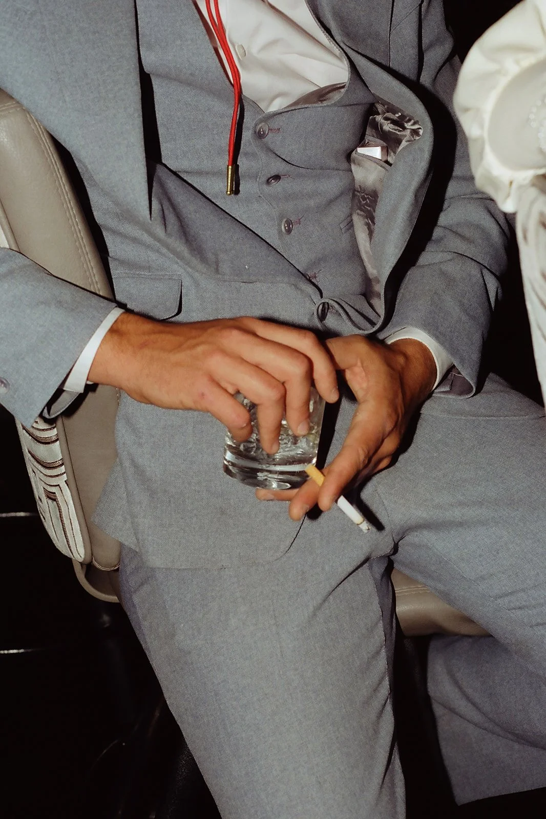 Close up shot of a man holding a glass and cigarette inside The Mint Tavern in Las Vegas.