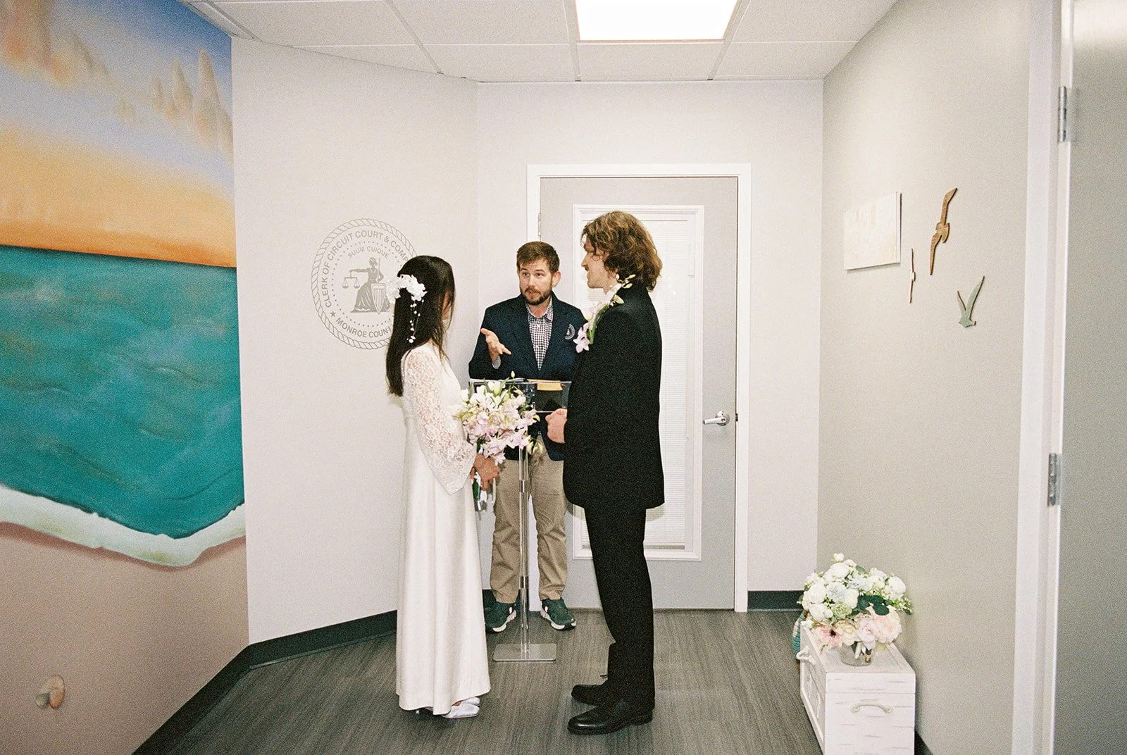 Couple holding hands at the altar at Monroe County Courthouse in Key West, FL