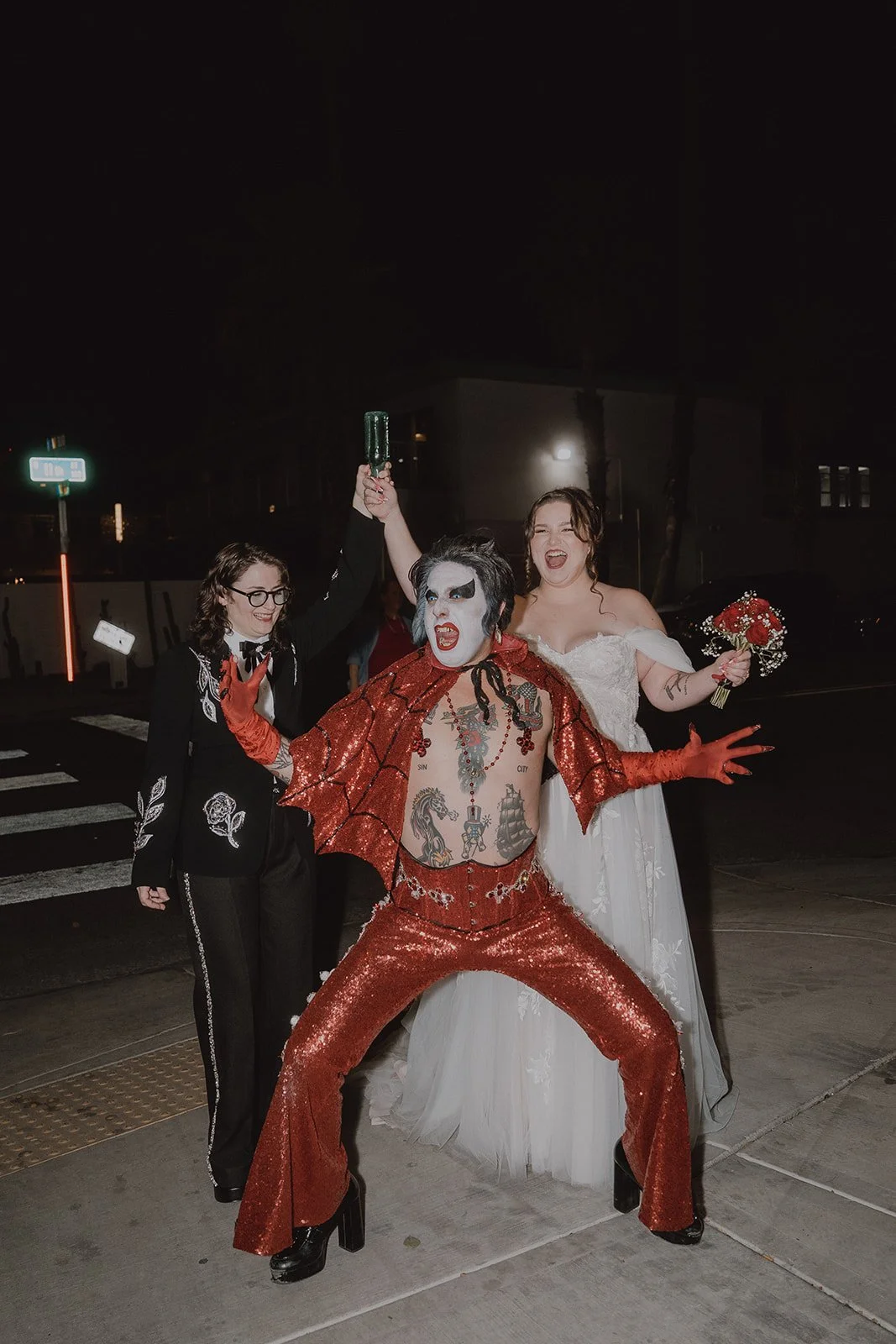 Couple just before breaking a prop bottle over the head of Hellvis outside  of Sure Thing Chapel.