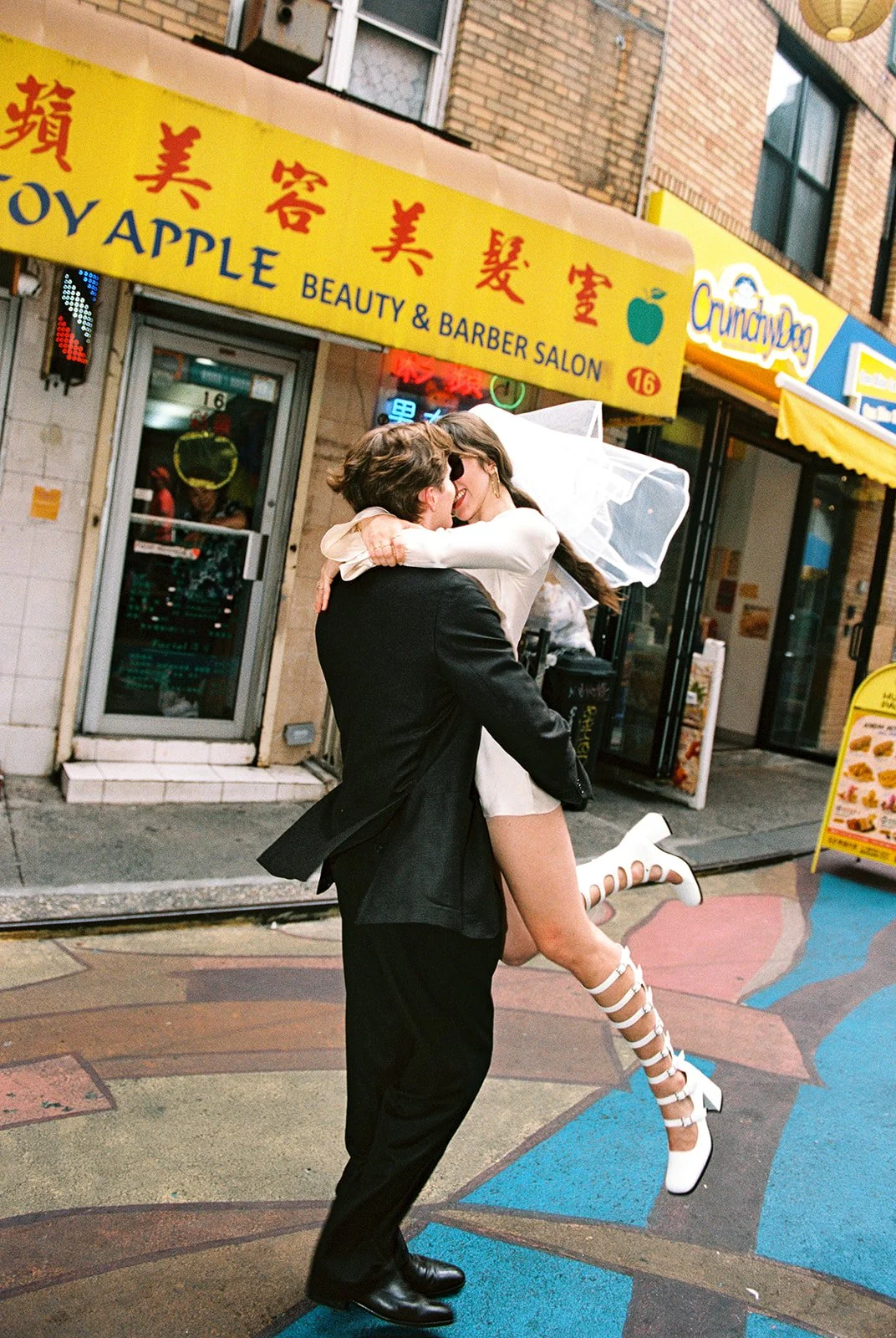 Couple kissing in Chinatown for their NYC elopement photos.