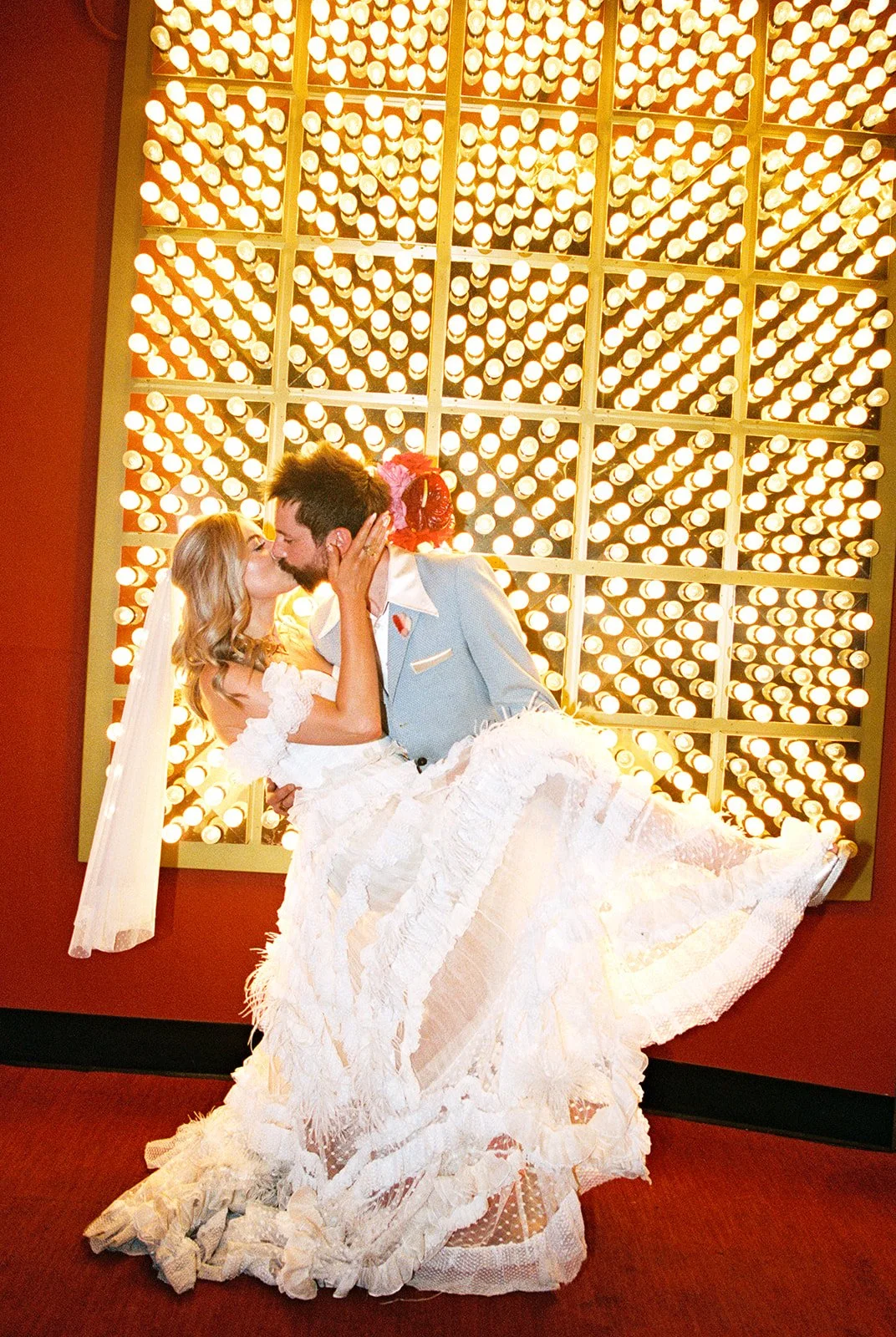 Bride and groom kissing in front of The Plaza in Las Vegas.