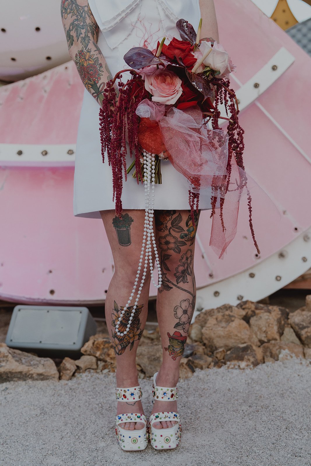 Close up shot of a brides beaded heels and colorful Las Vegas wedding bouquet.