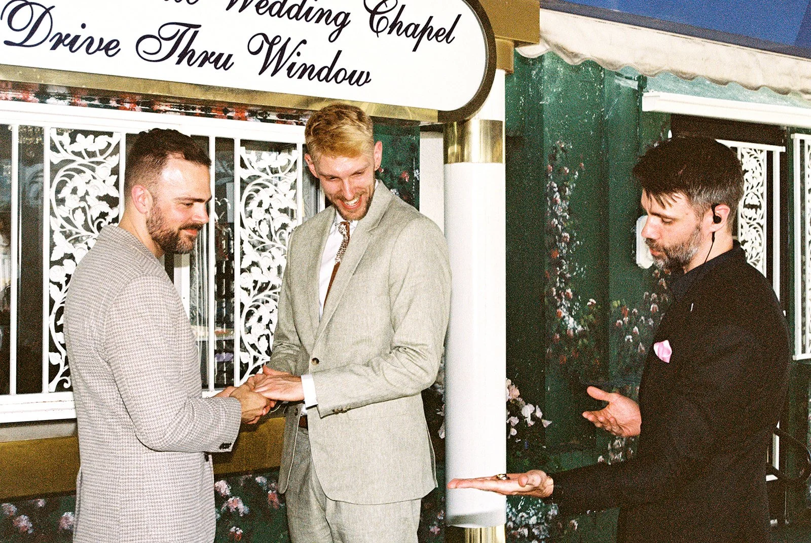 Officiant holding out the grooms rings during their ceremony.