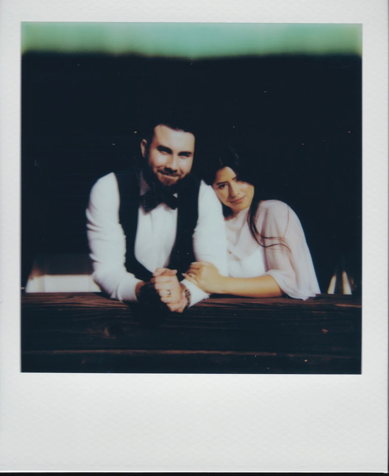 Polaroid photo of a couple posing at Benchmark Restaurant in Orange County during their micro wedding reception brunch.