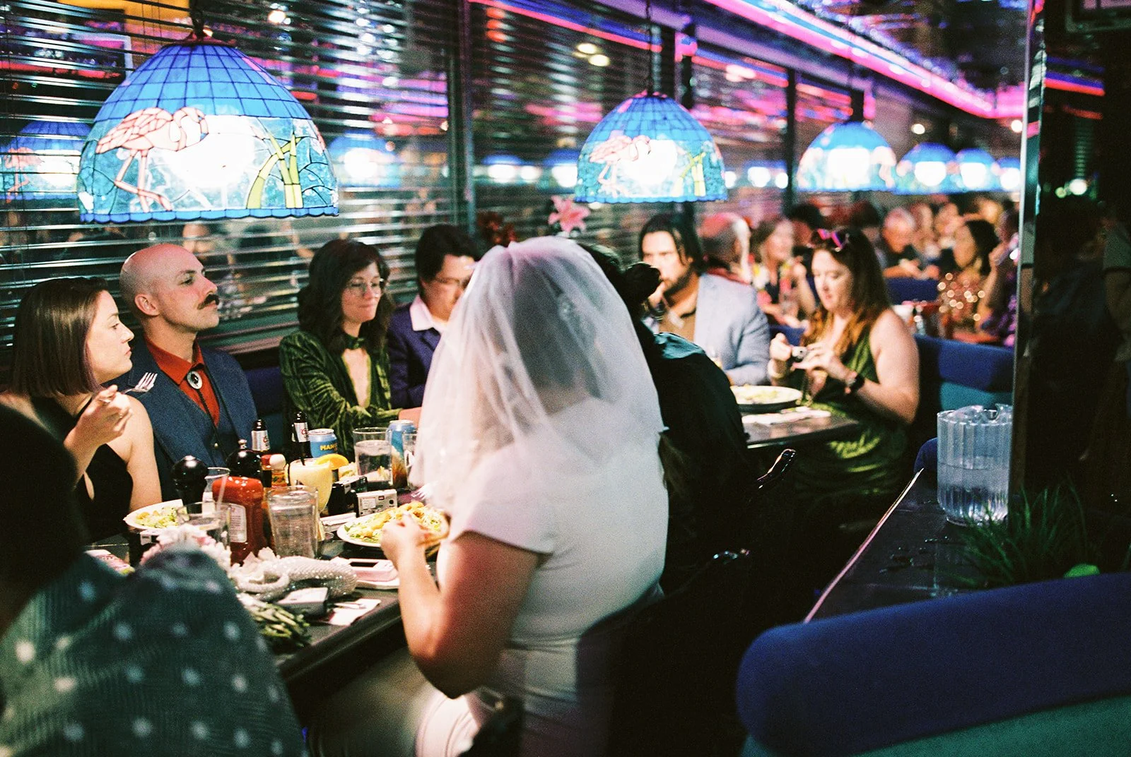 Couple and their wedding party eating inside Peppermill in Las Vegas.