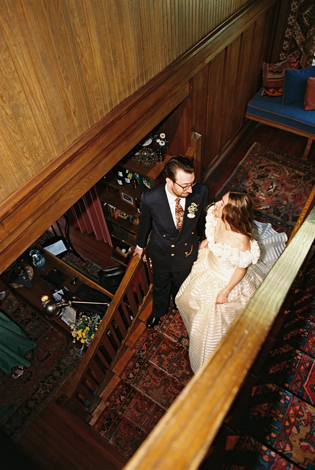 Film photo of a bride and groom walking down the stairs at Deer Mountain Inn.