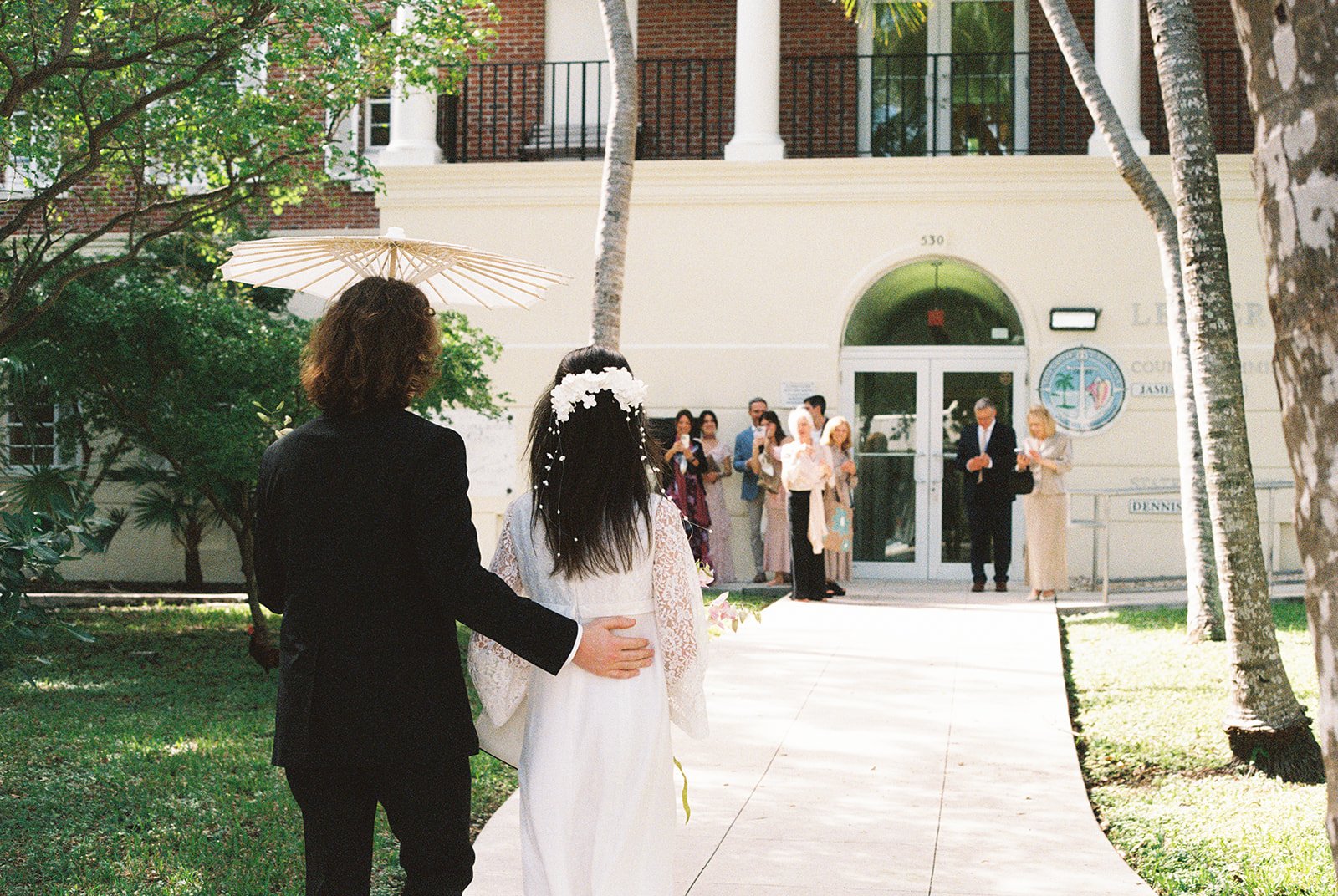 Couple walking up to Monroe County Courthouse in Key West, FL.