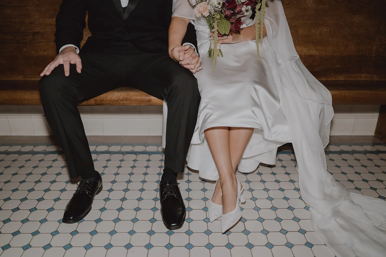 Close up shot of a couple sitting on a bench at Old Orange County Courthouse.