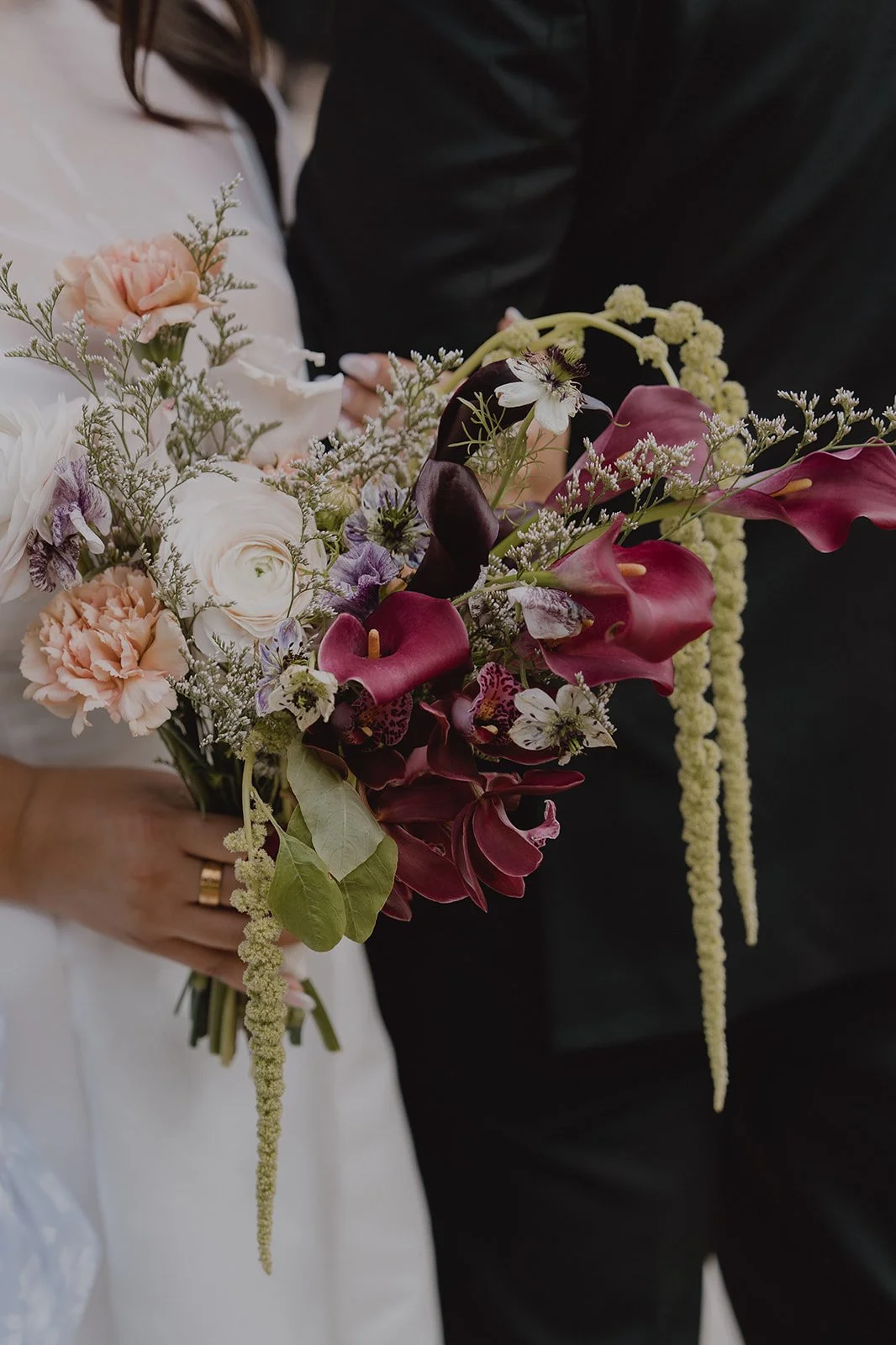 Close up shot of a bride and groom posing together outside of Old Orange County Courthouse.