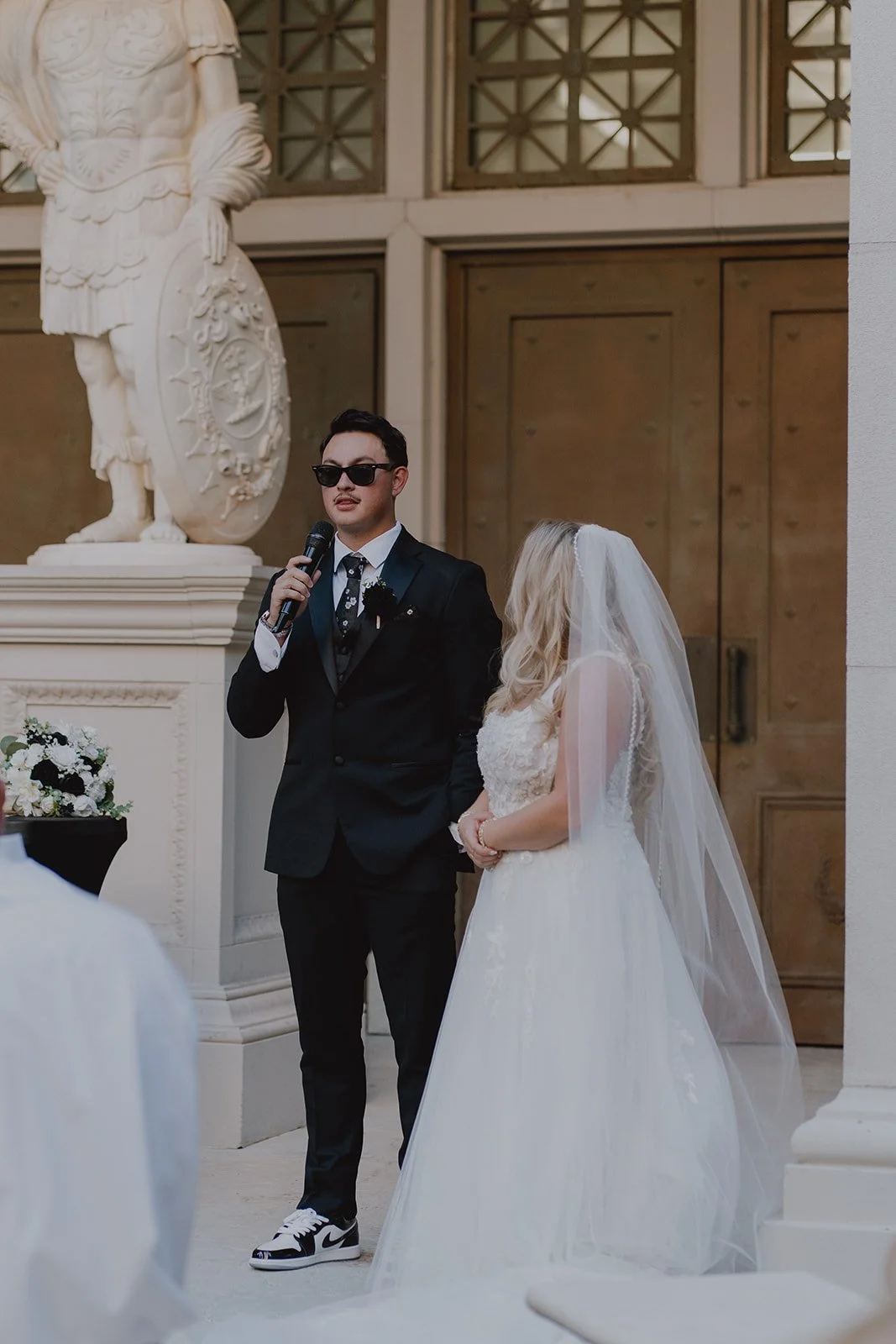 Bride and groom giving a speech to their guests.