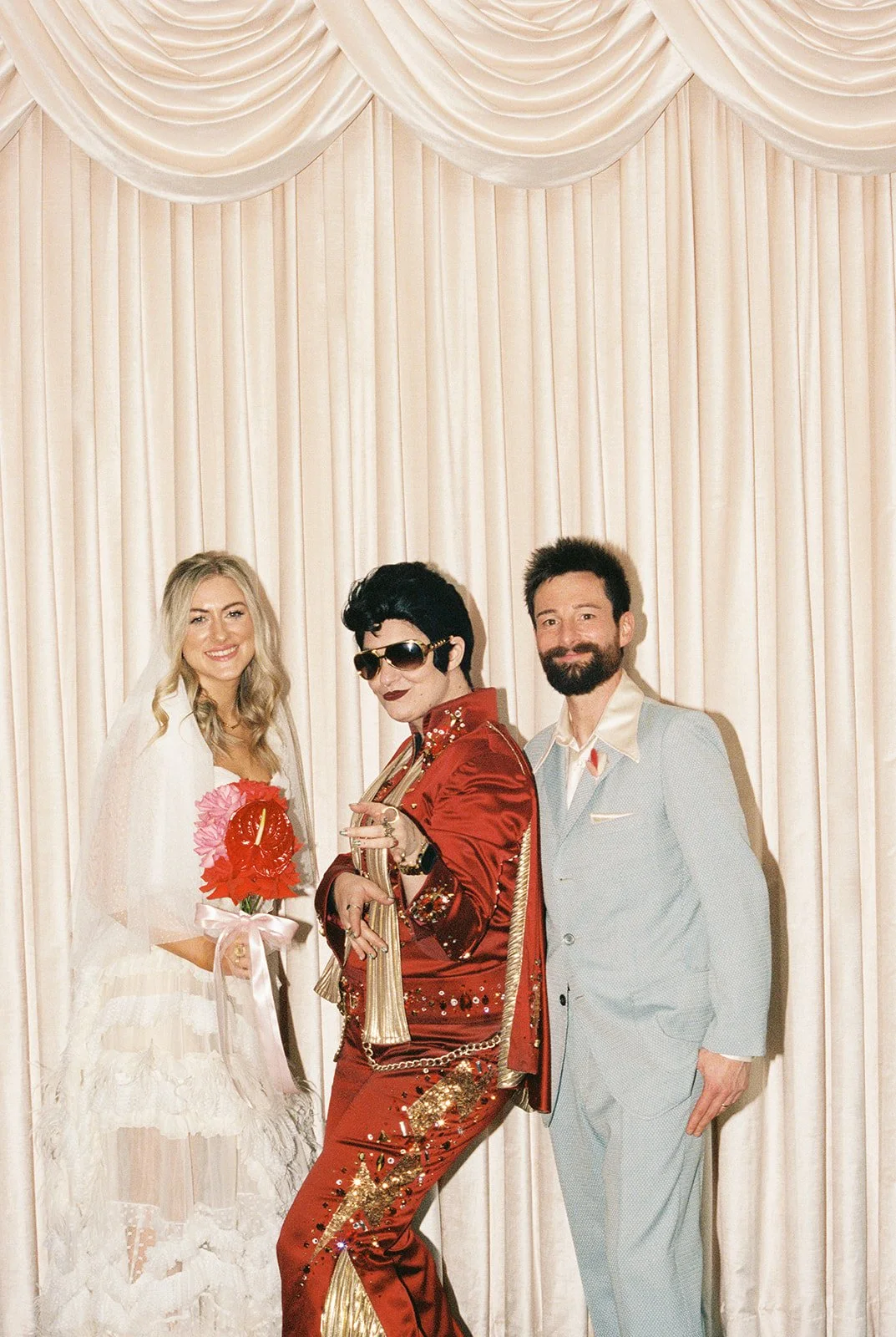 Bride and groom posing with Lady Elvis on 35mm film at Sure Thing Chapel in Las Vegas.