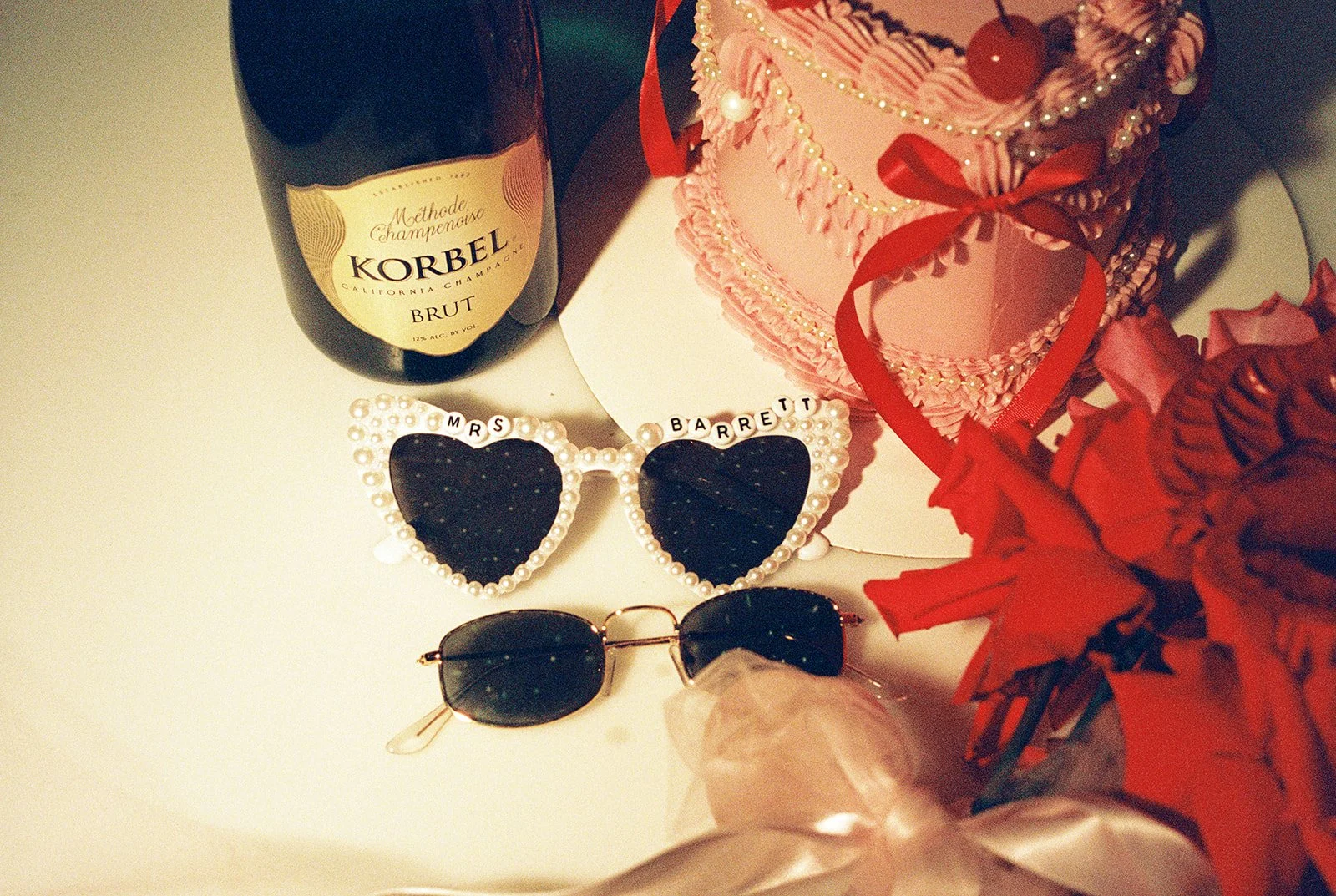 Close up shot of sunglasses, Las Vegas elopement cake, and Korbel Brut from a Las Vegas elopement.